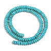 A strand of light blue turquoise stone beads coiled in a circular shape.