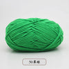 A ball of bright green pre-dyed milk cotton yarn, 50 grams, used for knitting and crochet.