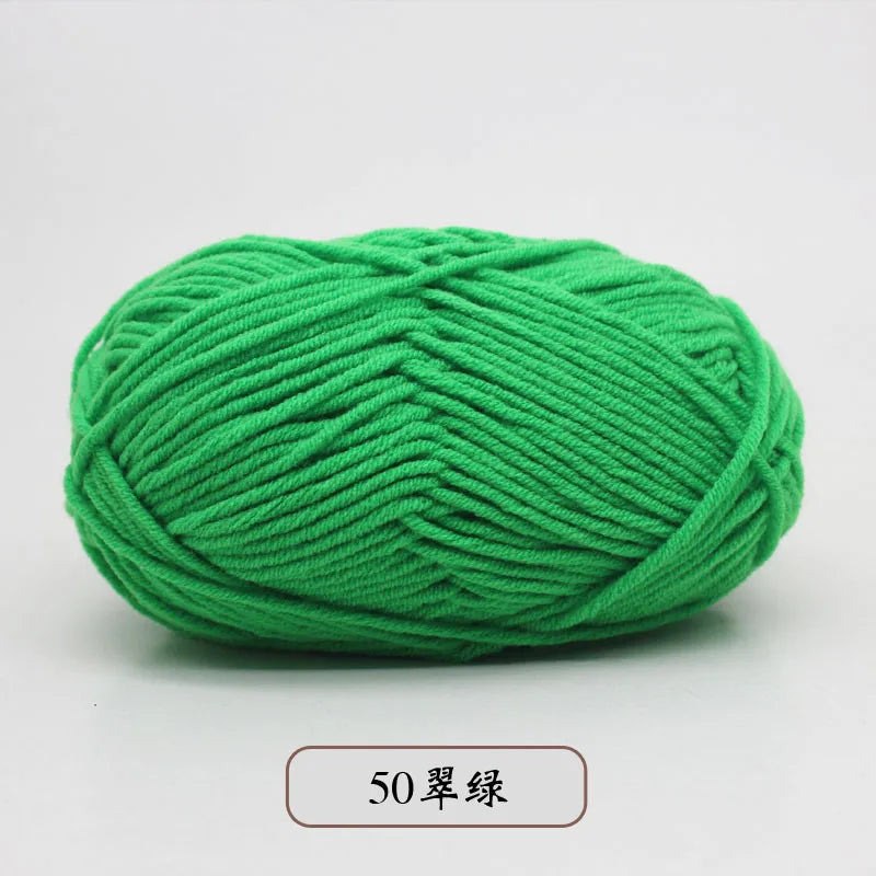 A ball of bright green pre-dyed milk cotton yarn, 50 grams, used for knitting and crochet.