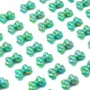 A collection of iridescent green acrylic bow beads used for jewelry making.