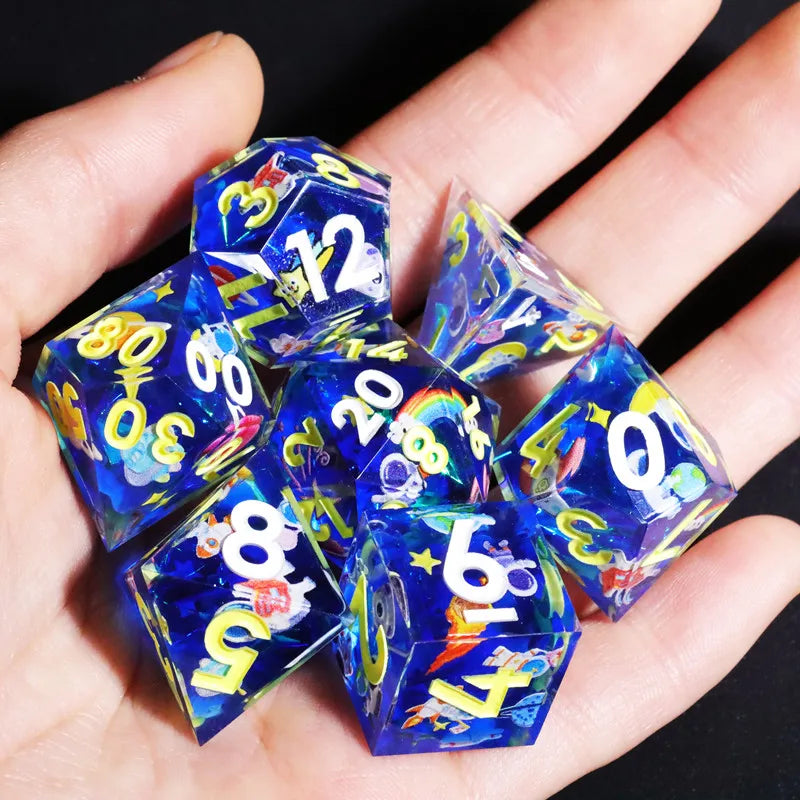 A hand holds a set of blue resin polyhedral dice on a dark background.