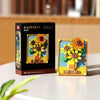 A box and assembled set of yellow and orange pixel art building blocks shaped like sunflowers.