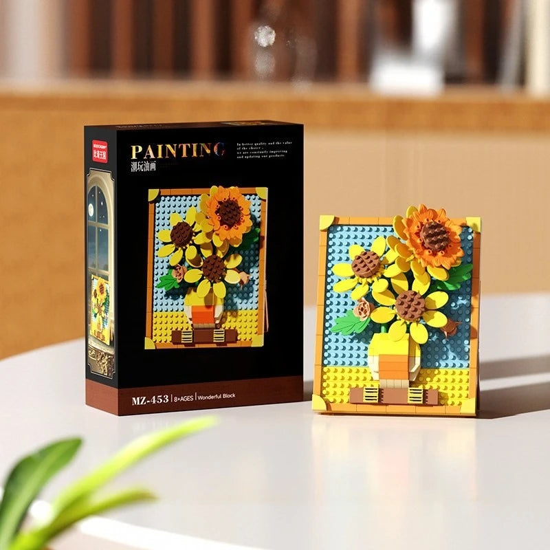 A box and assembled set of yellow and orange pixel art building blocks shaped like sunflowers.