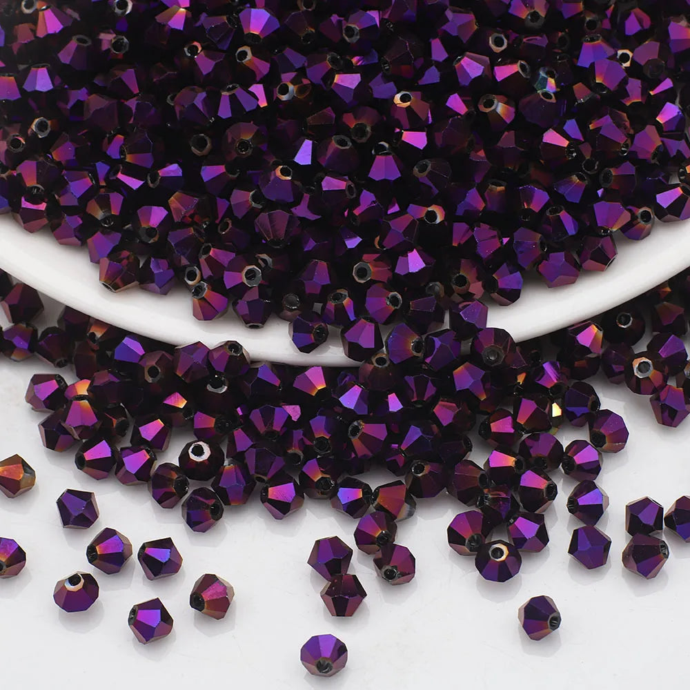 A pile of small, faceted purple and magenta crystal beads used for jewelry making.