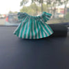 A green and white striped ruffled top for a fashion doll.