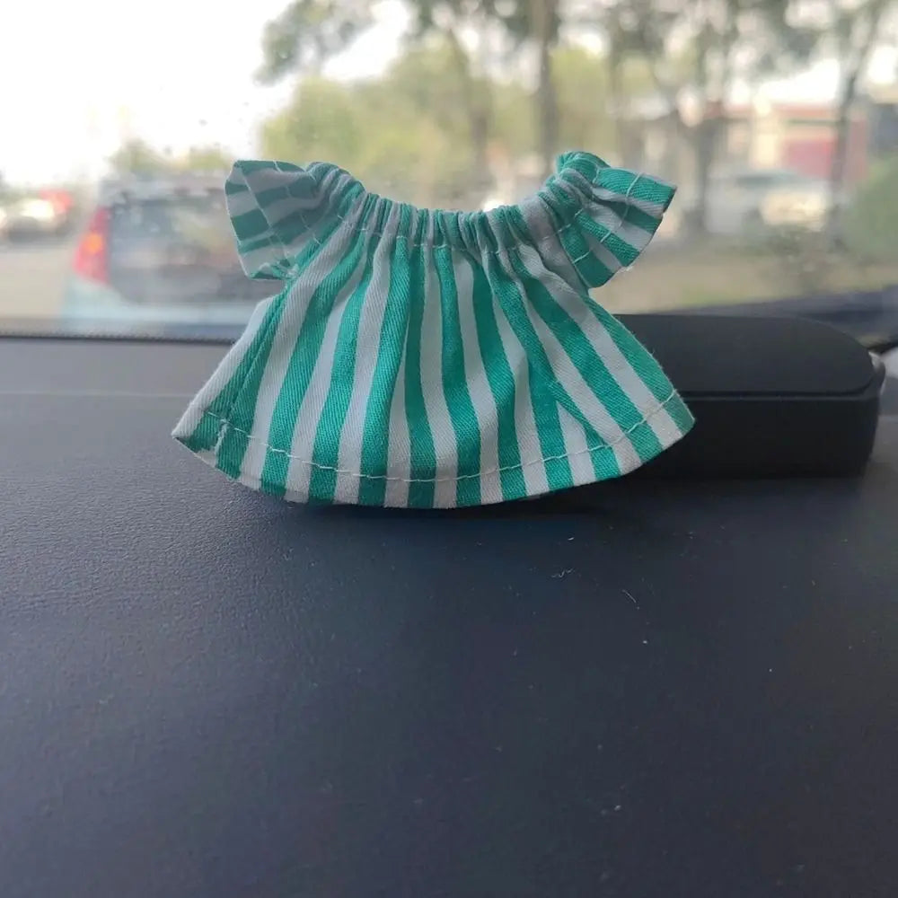 A green and white striped ruffled top for a fashion doll.
