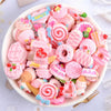 A bowl filled with assorted pink and colorful candy resin flatbacks for DIY crafts and jewelry making