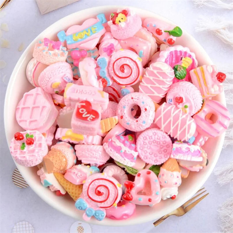 A bowl filled with assorted pink and colorful candy resin flatbacks for DIY crafts and jewelry making