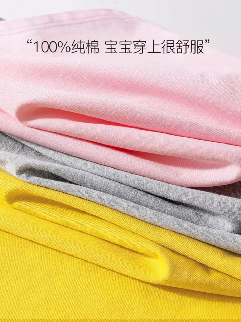 Pink, gray, and yellow t-shirts folded together showing fabric texture.