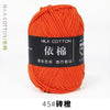A ball of bright orange milk cotton yarn labeled 45# and featuring the name 依棉 for knitting and crochet.