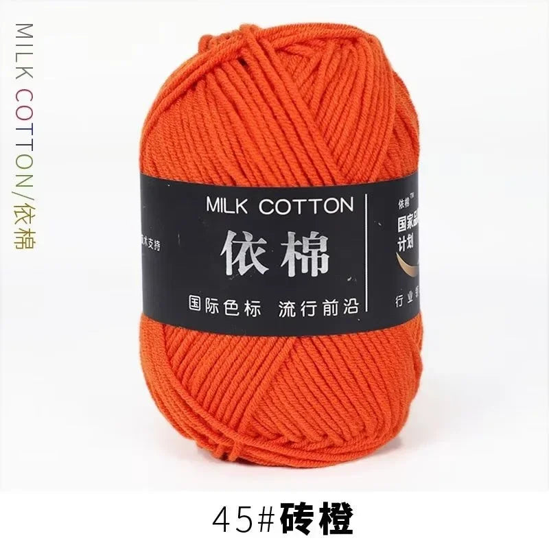 A ball of bright orange milk cotton yarn labeled 45# and featuring the name 依棉 for knitting and crochet.