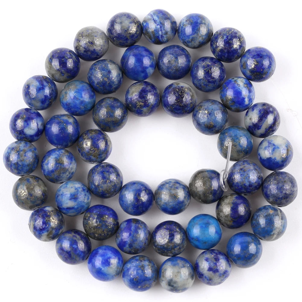A circular arrangement of polished blue and gray natural sea sediment jasper and turquoise beads for jewelry making
