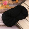 A ball of black yarn is shown on a wooden surface, with text indicating 34 color code and 1 piece equals 300g.