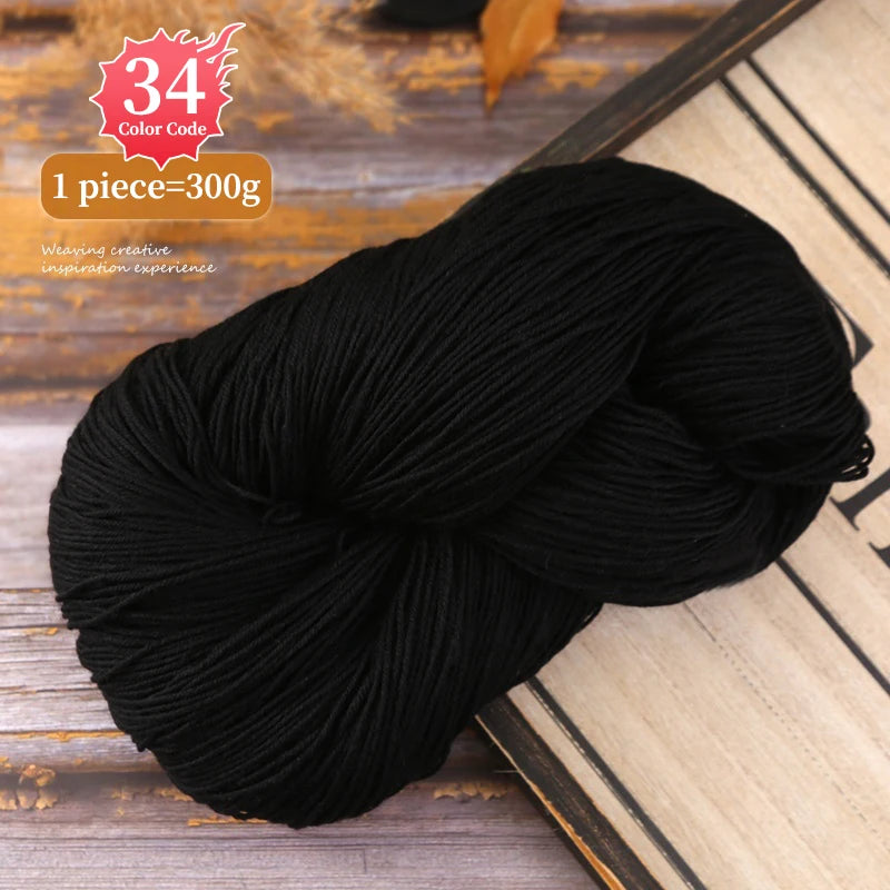 A ball of black yarn is shown on a wooden surface, with text indicating 34 color code and 1 piece equals 300g.