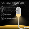 A white lamp with a flexible cord is shown illuminating a golden surface against a dark, starry background.