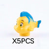 A yellow and blue plastic shark building block with a smiling face.