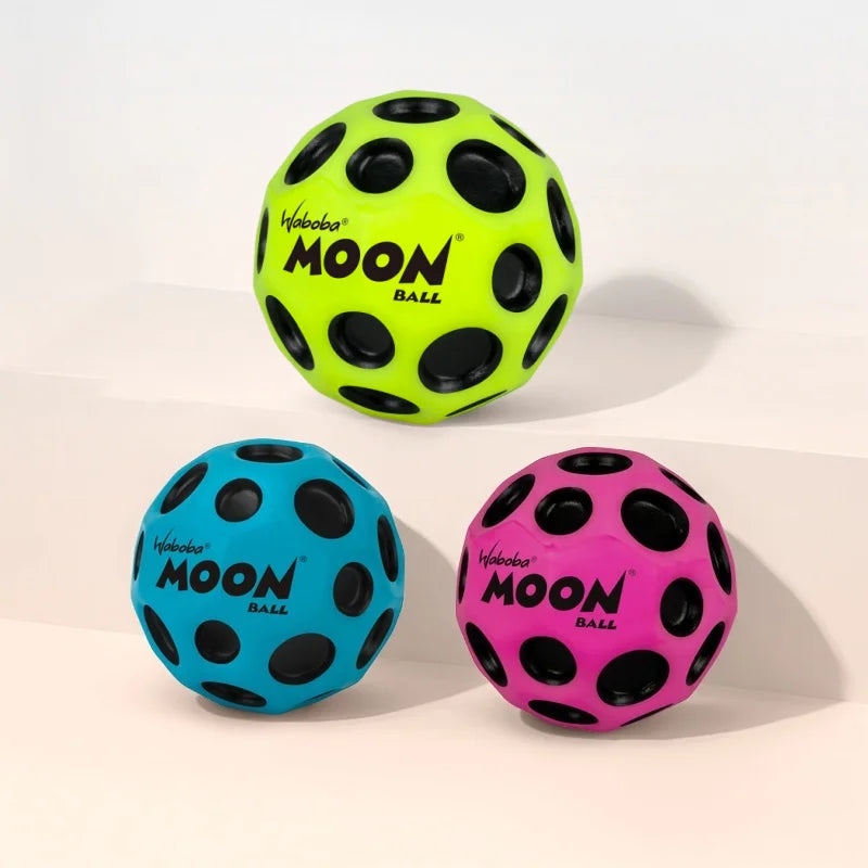 Three foam balls in neon yellow, blue, and pink, branded with the Moon Ball logo.