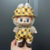 Labubu doll wearing a yellow and brown plaid outfit with a matching hat