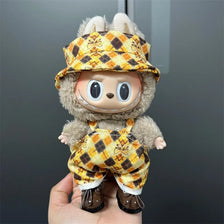 Labubu doll wearing a yellow and brown plaid outfit with a matching hat
