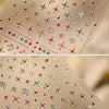 Close-up of sparkling 5D diamond nail art stickers on a translucent sheet with gold accents.