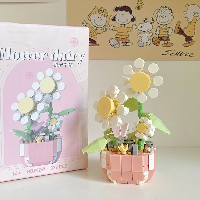 A pink box for a miniature flower bouquet building block set featuring white and yellow flowers.