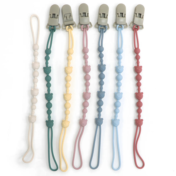 A set of silicone anti-loss pacifier clips in various pastel colors, including beige, green, yellow, pink, blue, and red.