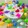 A collection of colorful squishy dinosaur fidget toys in various shades including pink, yellow, green, purple, and blue.