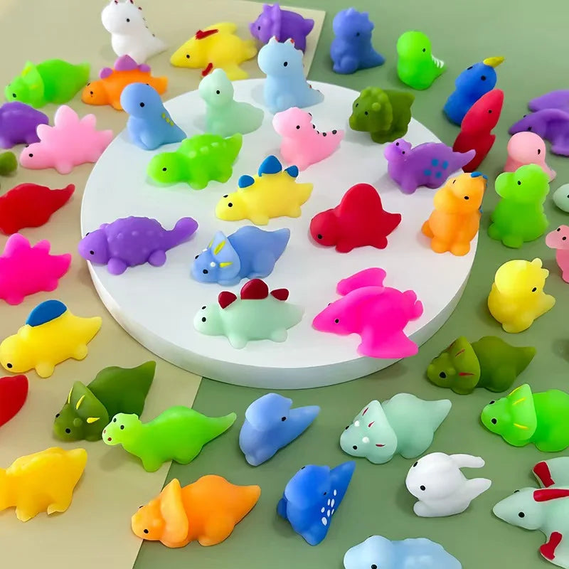A collection of colorful squishy dinosaur fidget toys in various shades including pink, yellow, green, purple, and blue.