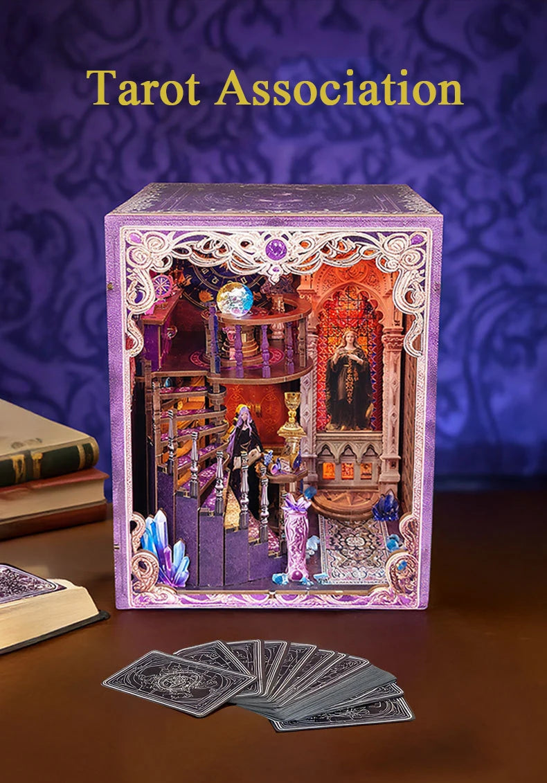 A purple box containing a tarot deck and accessories with LED lighting, next to a stack of books.