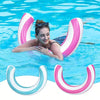 A woman is floating in blue water with a pink and white striped U-shaped inflatable pool float.