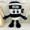 A black and white plush toy resembling a shark with a rectangular face and small sword-like appendages.