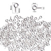 A pile of small silver metal eye pins used for jewelry making and DIY crafts.