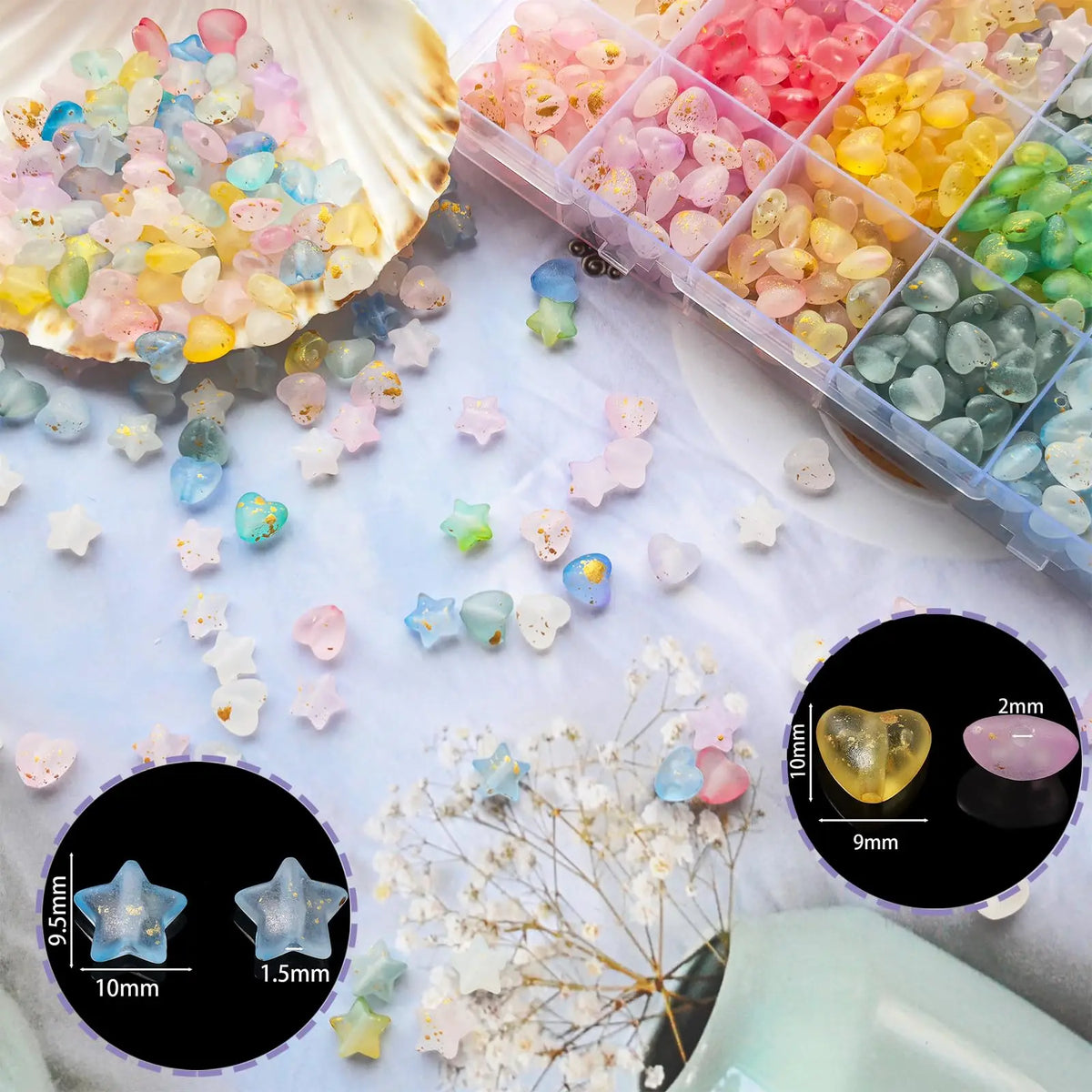 A collection of frosted golden foil acrylic beads and small floral elements scattered on a white surface.