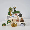 A stack of wooden animal blocks featuring various woodland creatures like a deer, hedgehog, and owl.