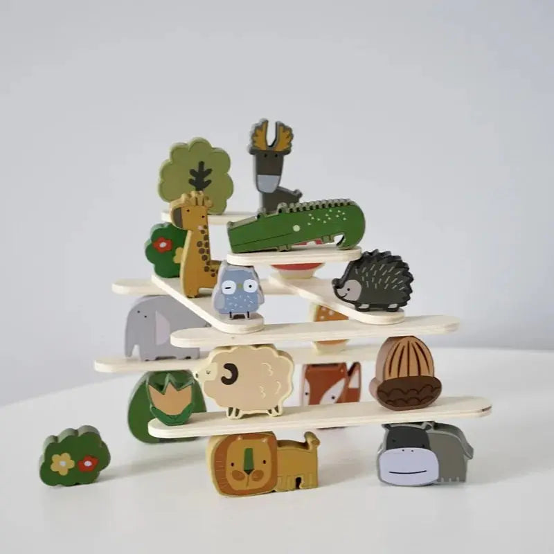A stack of wooden animal blocks featuring various woodland creatures like a deer, hedgehog, and owl.