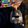 A fluffy gray bunny toy is being held by a person, with branding for the Liila Rainbow Candy Bunny series visible.