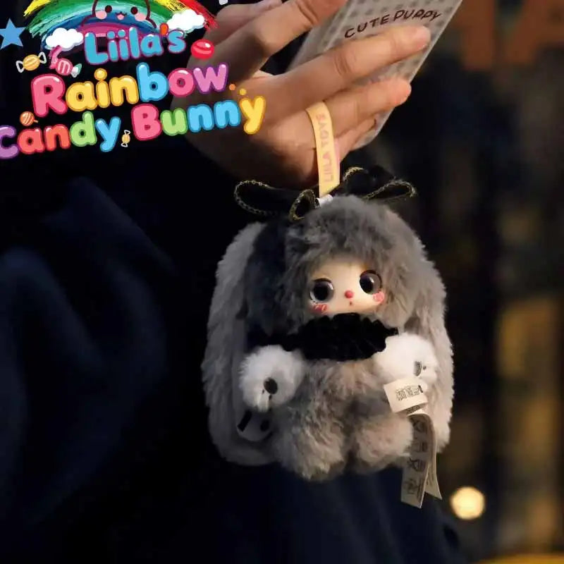 A fluffy gray bunny toy is being held by a person, with branding for the Liila Rainbow Candy Bunny series visible.