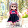 A 17cm articulated princess doll with long pink hair wearing a pink top and dark blue skirt.