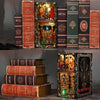 A collection of antique-style books and a decorative box featuring a haunted hotel theme.