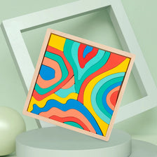 A colorful wooden puzzle featuring rainbow-like wavy lines, displayed in a white frame.