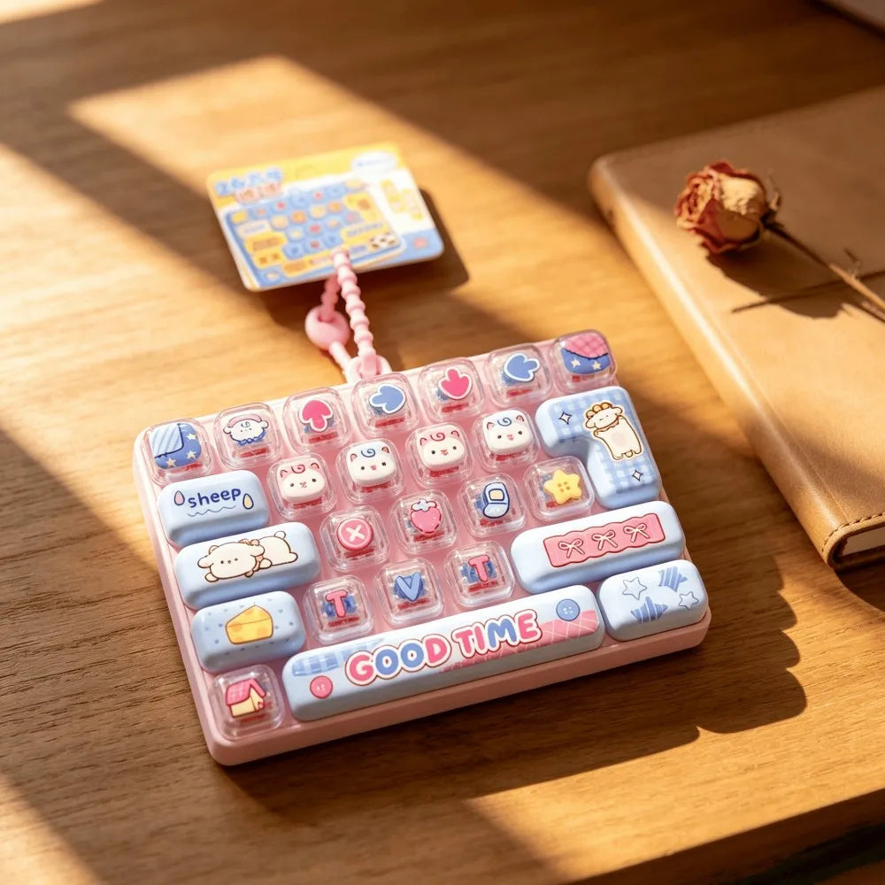 A pink keyboard keycap clicker with various colorful and themed keycaps resting on a wooden surface.