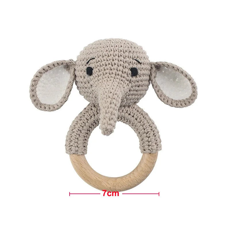 A light beige elephant wooden baby rattle and teether ring.