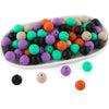 A white oval dish filled with various colored round silicone beads for jewelry making and crafts.