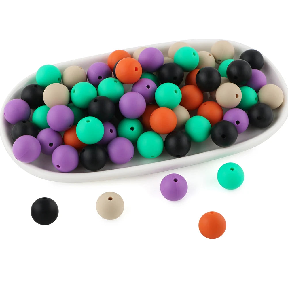 A white oval dish filled with various colored round silicone beads for jewelry making and crafts.