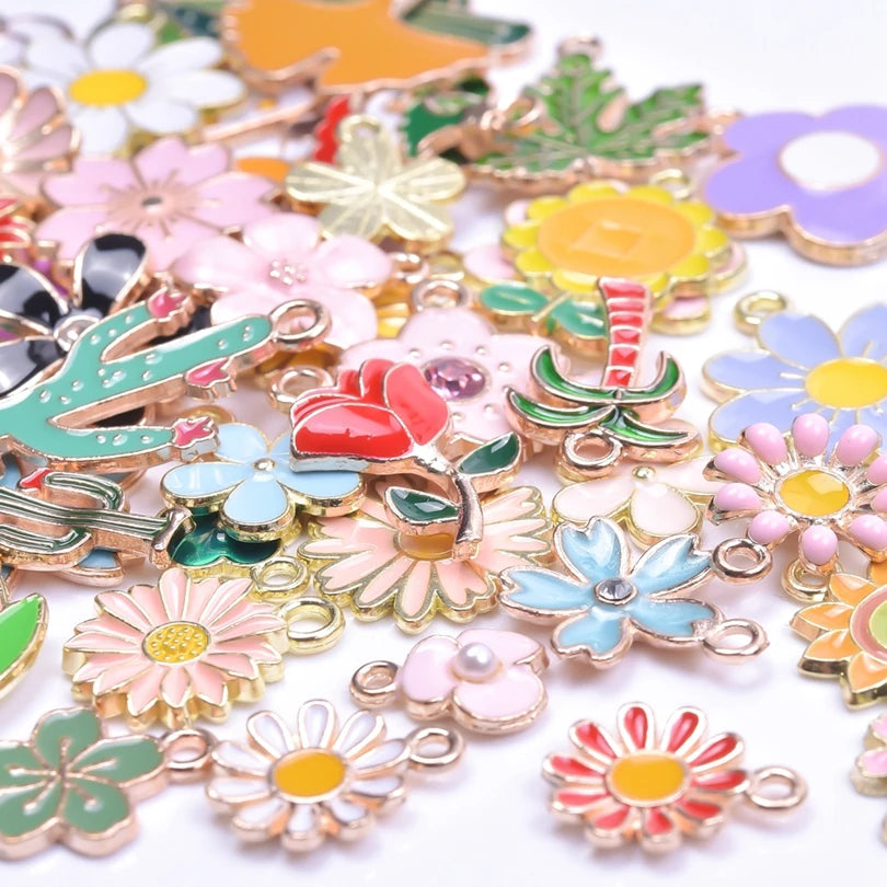 Assortment of gold-tone enamel charms featuring various floral shapes and colors for jewelry making