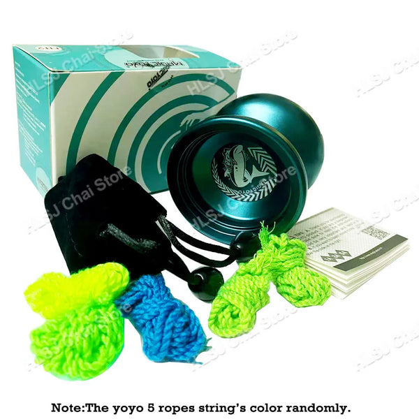 A black metal shark yoyo and five brightly colored yarn strings are displayed next to its packaging box.