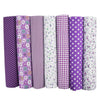 A pack of seven rolls of purple and white striped cotton fabric squares for quilting and patchwork