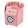 A pink vintage rotary telephone piggy bank with a coin slot and bill slot.