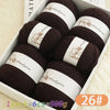A box of dark brown wool yarn skeins labeled Woolyarn for knitting with a 26# size.