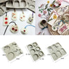 A collection of hexagonal silicone molds for handmade soap and candles in various colors and floral designs.